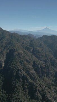 Vertical drone video. Rock formations, forested mountains and large formations. Hiking through the green forest. Hiking concept. Amatlan, Mexico
