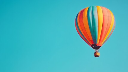 Naklejka premium A hot air balloon in vivid hues, captured as it ascends against a cloudless blue sky, creating a sense of adventure and wonder 