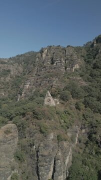 Vertical drone video. Rock formations, forested mountains and large formations. Hiking through the green forest. Hiking concept. Amatlan, Mexico
