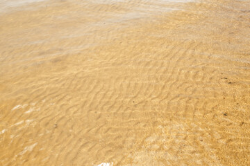 clear shallow lake with sandy bottom close up