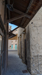 Fototapeta premium Street of Dubai old city or town Al Seef Khor in Al Fahidi neighborhood, United Arab Emirates. Vertical image