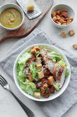 A bowl  of  Caesar salad