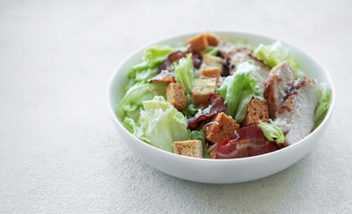 A bowl  of  Caesar salad