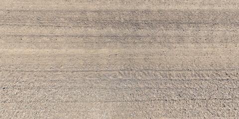 view from above on texture gravel road with median with lawn