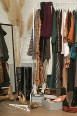 Untidy cluttered woman wardrobe with stylish clothes and accessories. Messy clothes thrown on a...