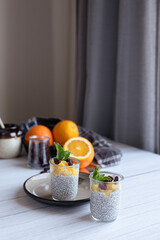 Chia pudding on white wooden table. 