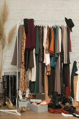 Untidy cluttered woman wardrobe with stylish clothes and accessories. Messy clothes thrown on a...