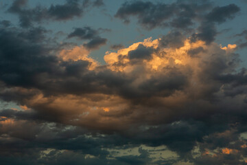 Cloudscape, Colored Clouds at Sunset near the Ocean in a Cloudy Day