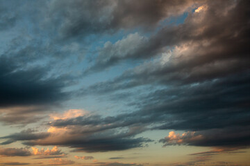 Cloudscape, Colored Clouds at Sunset near the Ocean in a Cloudy Day