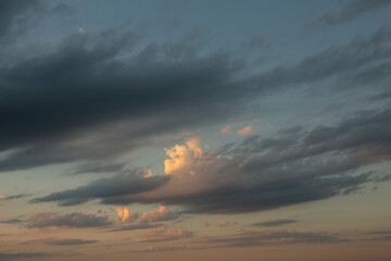 Cloudscape, Colored Clouds at Sunset near the Ocean in a Cloudy Day