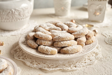 Vanilla crescents - traditional Christmas cookies coated in sugar on a white plate