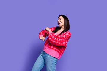 Photo of adorable cool girl wear pink cardigan dancing empty space isolated purple color background