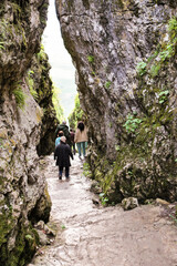 People in a narrow passage between the rocks.