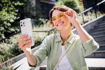 Photo of charming cheerful lovely girl popular influencer making selfie lifestyle blog enjoying...