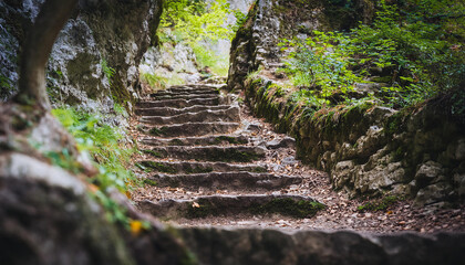 Old stone stairs leading to the cave. Rocky hills. Beautiful wildlife. Ancient architecture.