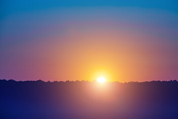 A beautiful sunset with a bright orange sun in the sky