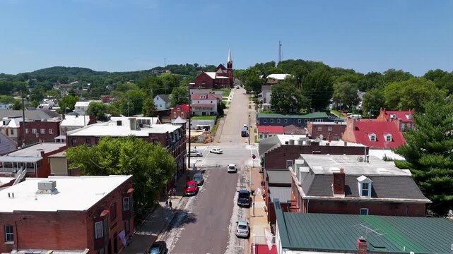 Aerial-Establishing shot-Hermann, Missouri over 4th Street up the hill to St George Catholic Church and school