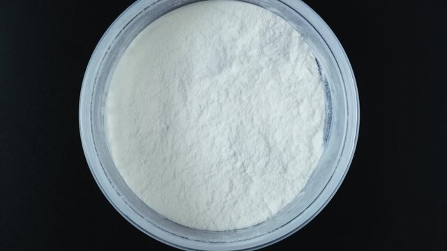Powder of Microbial transglutaminase also called microbial TGase, MTGase, or meat glue. Processing aid is used to bond proteins together. Dangerous food additives. 4K Video, Rotating.