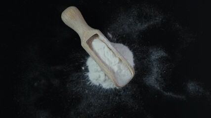 Powdered meat glue or Transglutaminase is scattered on a dark surface. Turntable. 4K Video, Rotating. Dangerous food additives. Microbial TGase or MTGase used in molecular gastronomy.