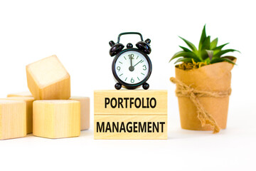 Portfolio management symbol. Concept words Portfolio management on beautiful wooden block. Beautiful white paper background. Black alarm clock. Business Portfolio management concept. Copy space.