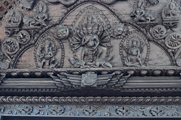 Decorative wood carvings inside a Hindu temple in Pokhara, Nepal.