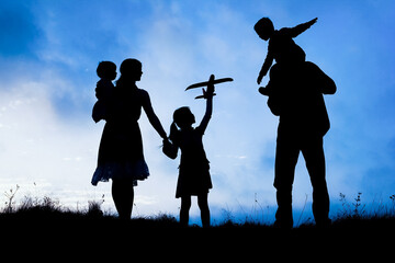 happy family by the sea on nature silhouette background