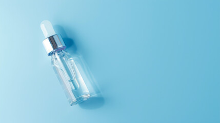 Clear glass pipette with anti-age face serum on blue background