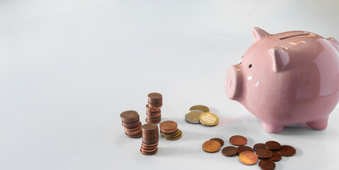 A piggy bank and coin on a white background, concept of savings