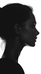 A graceful outline of a woman's profile illuminated by bright light