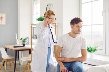 Doctor with stethoscope listening to heartbeat, back heart, lungs for male health care, female doctor in clinic checking up regular exam, patient healthcare in hospital for professional controlling 