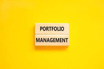 Portfolio management symbol. Concept words Portfolio management on beautiful wooden block. Beautiful yellow paper background. Business Portfolio management concept. Copy space.