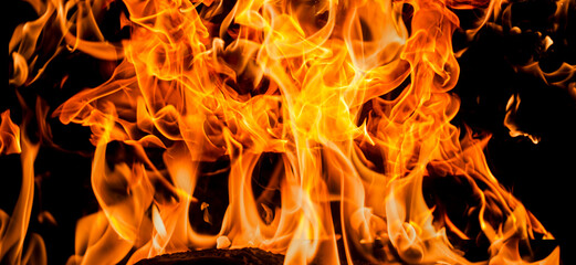 Fire flames on black background. Fire sparks background. Abstract dark fire flames background....