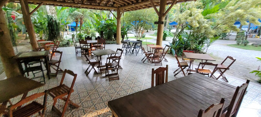 wooden tables and chairs in outdoor eating area