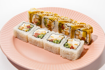 Tempura Chicken and Vegetable Sushi Roll with Curry Sauce on Pink Plate