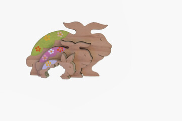 Wooden rabbit family puzzle on white background.