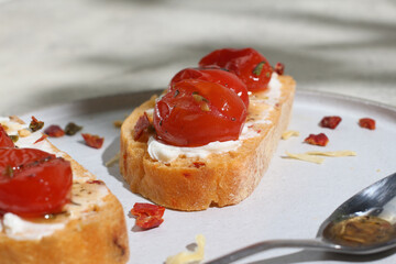 Bruschetta with tomatoes and cream cheese.