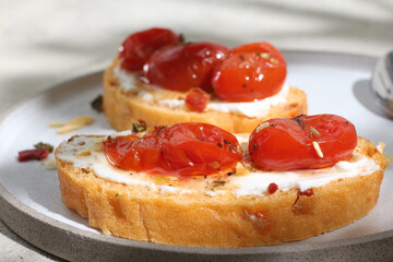 Bruschetta with cheese, spices and cherry tomatoes