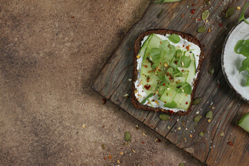 Healthy eating concept with diet laid out in greens on dark Borodino bread, symbolizing nutritious food choices