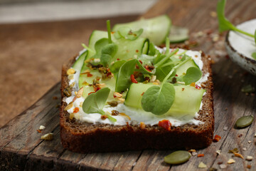Healthy eating concept with diet laid out in greens on dark Borodino bread, symbolizing nutritious food choices