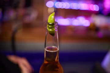 Enjoying a Refreshing Beer with a Lime Slice Placed on Top for Extra Flavor and Zest