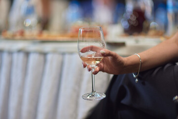 At a lively nightclub, people are enjoying wine and socializing in a chic ambiance