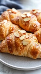 Close-up of freshly baked almond croissants on a plate