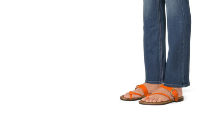 Closeup of woman's feet in orange sandals on white copy-space background.