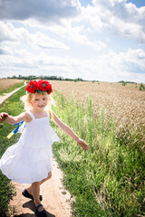 Young Girl in White Dress Celebrating Ukraine's Independence Day in a Wheat Field