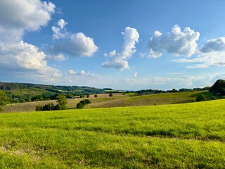 Blick über eine schöne hügelige Landschaft mit Wiesen und Weiden, einzelnen Bäumen und kleinen Wäldern im Bergischen Land, Wiehl, Nümbrecht, Oberbergischen Kreis, Nordrhein-Westfalen, Deutschland