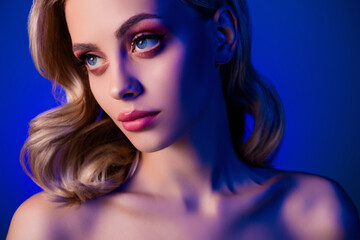 Fototapeta premium Photo of pretty girl with blonde hair curls look profile side isolated neon color blue background
