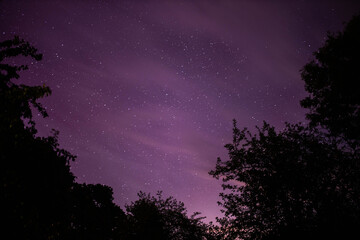 bright red-violet sky northern lights and sun flares starry sky