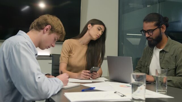 Business partners colleagues men woman office coworking group male female girl guys interns writing working conference table multiethnic diverse employees businessmen businesswoman boring use devices