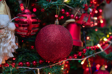 Christmas toy ball on the Christmas tree surrounded by festive lights. Holiday. New Year. Christmas. selective focus.