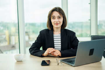 Young woman working in a spacious office. Successful people are working on a new business project. Collective work in the office